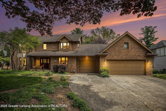 3796 Viceroy Dr, Okemos, MI 48864 - traditional-style house featuring a garage, driveway, brick siding, a front yard, and roof with shingles