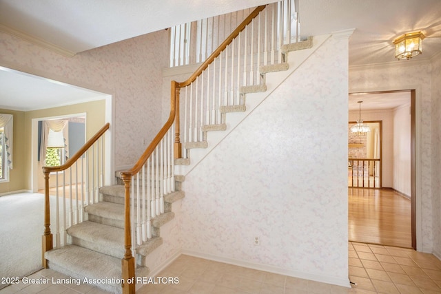 3796 Viceroy Dr, Okemos, MI 48864 - stairway featuring crown molding, a chandelier, wallpapered walls, tile patterned flooring, and baseboards