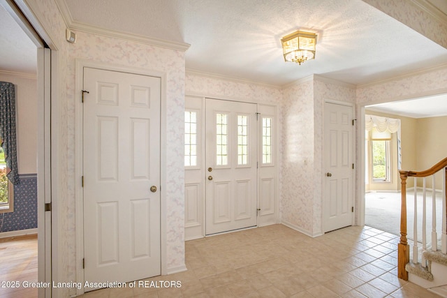 3796 Viceroy Dr, Okemos, MI 48864 - foyer entrance with wallpapered walls, stairs, crown molding, baseboards, and light tile patterned floors