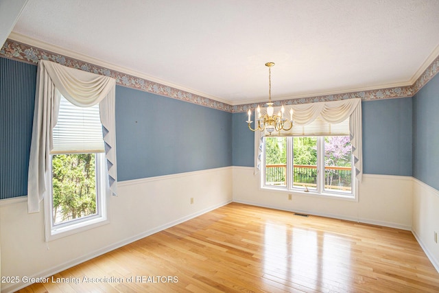 3796 Viceroy Dr, Okemos, MI 48864 - spare room with a chandelier, wood finished floors, ornamental molding, and baseboards