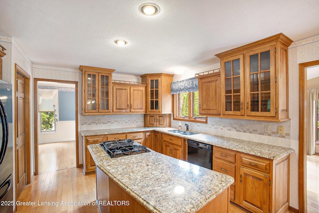 3796 Viceroy Dr, Okemos, MI 48864 - kitchen featuring black appliances, wallpapered walls, a textured ceiling, brown cabinets, and light wood-type flooring