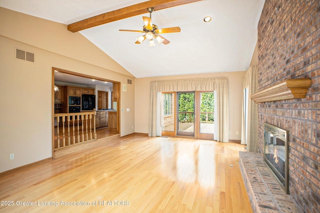 3796 Viceroy Dr, Okemos, MI 48864 - unfurnished living room with a brick fireplace, light wood finished floors, a ceiling fan, and baseboards