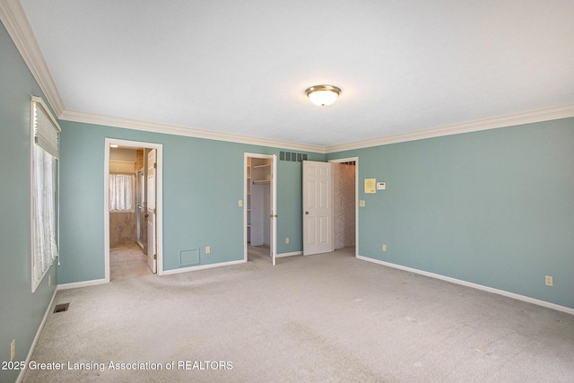 3796 Viceroy Dr, Okemos, MI 48864 - unfurnished bedroom featuring ornamental molding, baseboards, carpet, a spacious closet, and ensuite bathroom