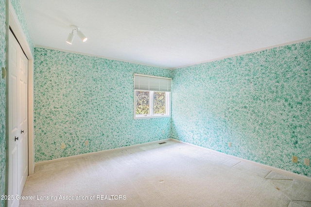 3796 Viceroy Dr, Okemos, MI 48864 - empty room with wallpapered walls, carpet, and baseboards