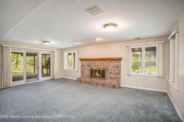 3796 Viceroy Dr, Okemos, MI 48864 - unfurnished living room featuring baseboards, carpet floors, a brick fireplace, and a textured ceiling