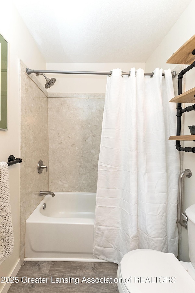 bathroom featuring toilet, shower / bath combination with curtain, and wood finished floors