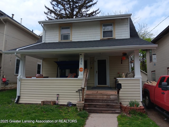 view of front of house with a porch and a shingled roof