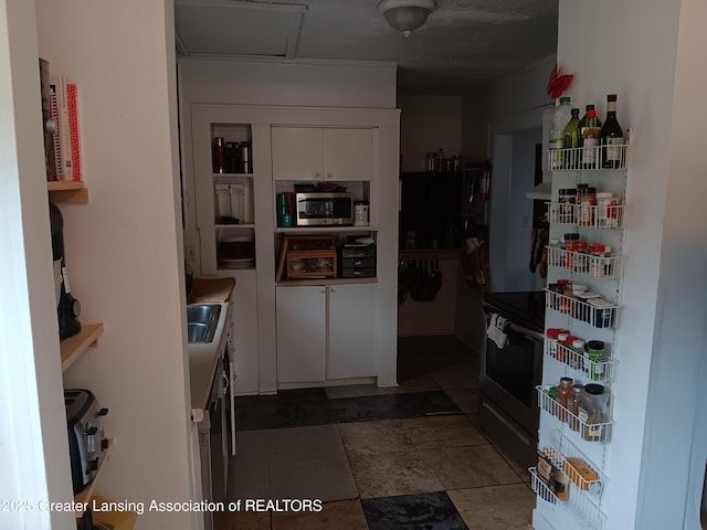 kitchen with stainless steel microwave and white cabinetry