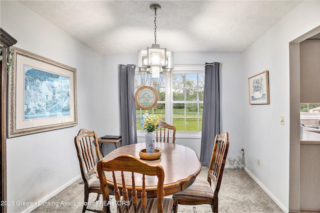 11190 Cobblestone Ln, Grand Ledge, MI 48837 - dining space featuring light carpet, a textured ceiling, a chandelier, and baseboards