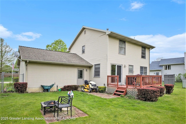 11190 Cobblestone Ln, Grand Ledge, MI 48837 - back of house featuring an outdoor fire pit and a deck
