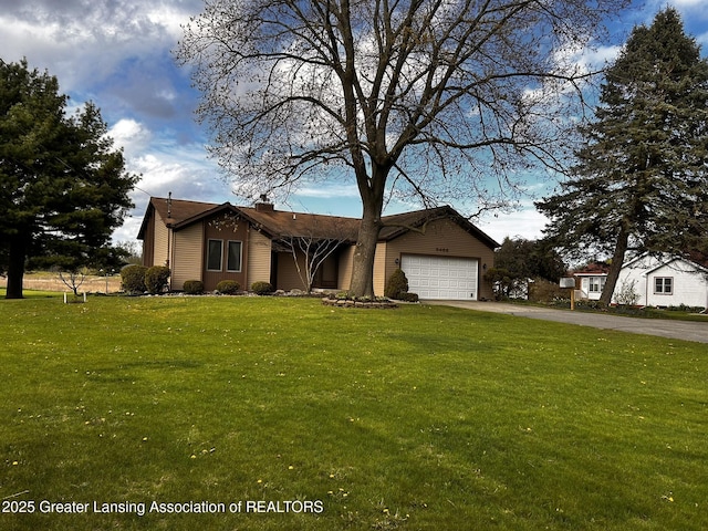 9466 W Grand River Ave, Grand Ledge, MI 48837 - view of front of home with a garage, a chimney, a front yard, and aphalt driveway