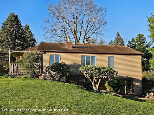 9466 W Grand River Ave, Grand Ledge, MI 48837 - view of home's exterior with a lawn and a chimney