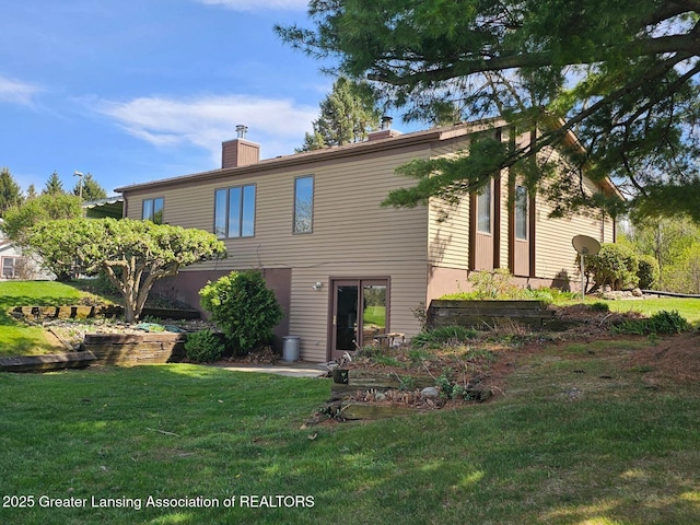 9466 W Grand River Ave, Grand Ledge, MI 48837 - view of front of home with a front yard and a chimney