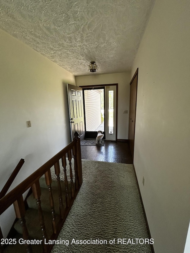 9466 W Grand River Ave, Grand Ledge, MI 48837 - hallway with a textured ceiling and baseboards