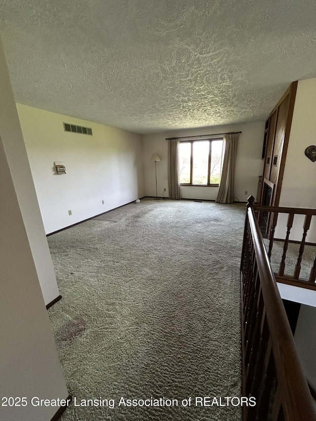 9466 W Grand River Ave, Grand Ledge, MI 48837 - carpeted empty room featuring a textured ceiling and visible vents