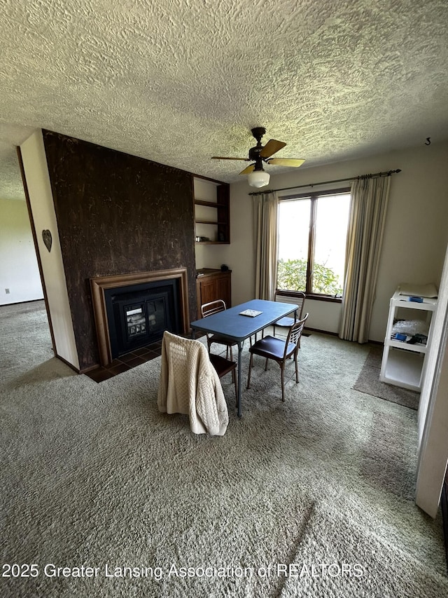 9466 W Grand River Ave, Grand Ledge, MI 48837 - carpeted dining room with a ceiling fan, a textured ceiling, and a large fireplace