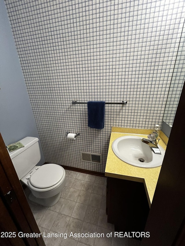 9466 W Grand River Ave, Grand Ledge, MI 48837 - half bathroom with vanity, toilet, and visible vents
