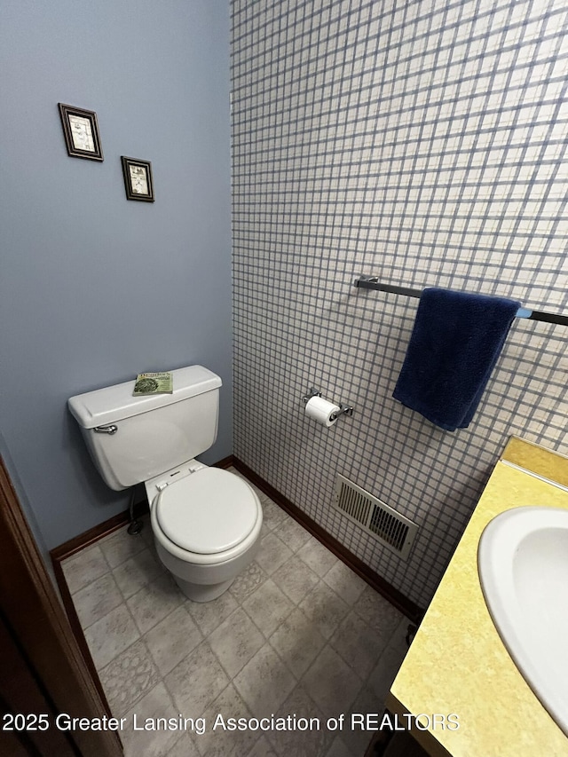 9466 W Grand River Ave, Grand Ledge, MI 48837 - bathroom with baseboards, a sink, and toilet