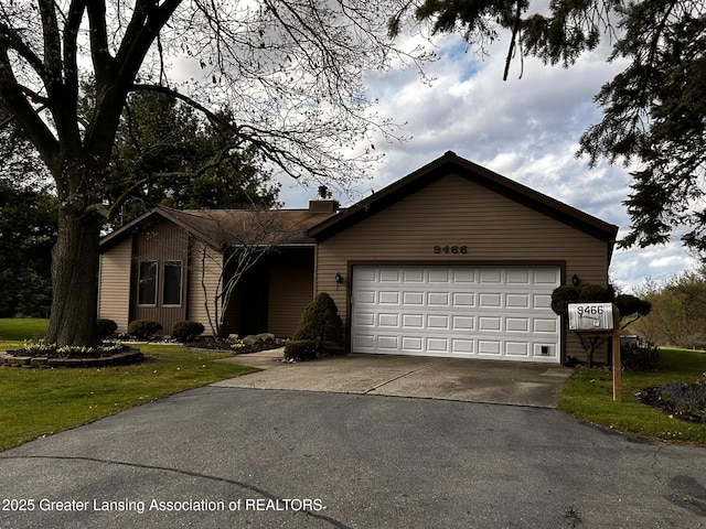 9466 W Grand River Ave, Grand Ledge, MI 48837 - single story home featuring concrete driveway, a chimney, a front lawn, and a garage