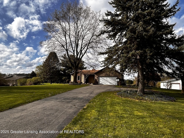 9466 W Grand River Ave, Grand Ledge, MI 48837 - view of front facade with a garage, aphalt driveway, and a front yard