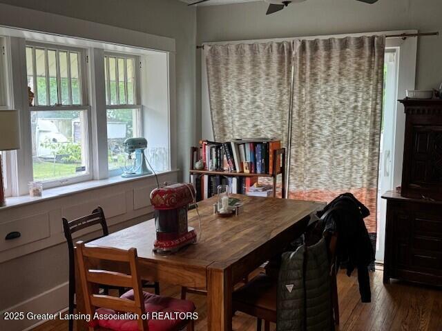 dining space featuring wood finished floors and ceiling fan