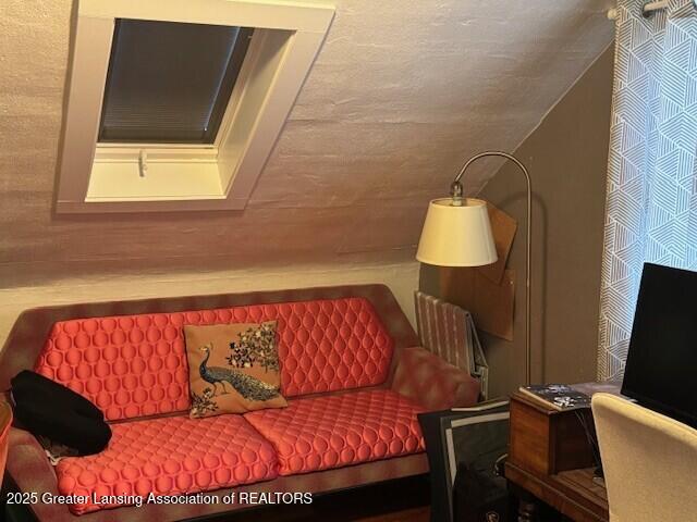 sitting room with lofted ceiling