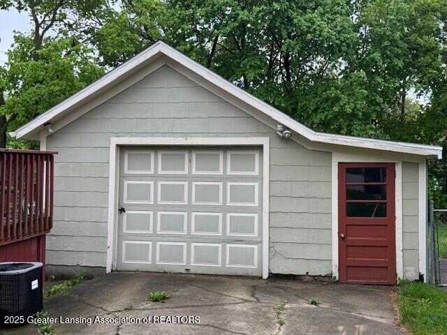 detached garage with driveway and central AC