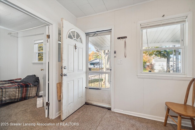 4125 Lowcroft Ave, Lansing, MI 48910 - entryway featuring baseboards, ornamental molding, and carpet