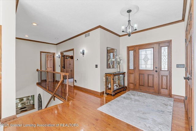 3012 Appaloosa Way, Lansing, MI 48906 - foyer entrance with baseboards, wood finished floors, and a chandelier