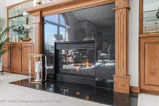 3012 Appaloosa Way, Lansing, MI 48906 - details featuring a glass covered fireplace, carpet, and ornate columns
