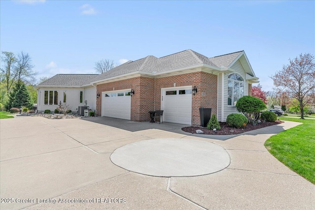3012 Appaloosa Way, Lansing, MI 48906 - view of home's exterior featuring a shingled roof, an attached garage, concrete driveway, and brick siding