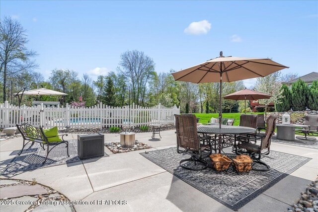 3012 Appaloosa Way, Lansing, MI 48906 - view of patio / terrace with fence, outdoor dining space, and a fenced in pool