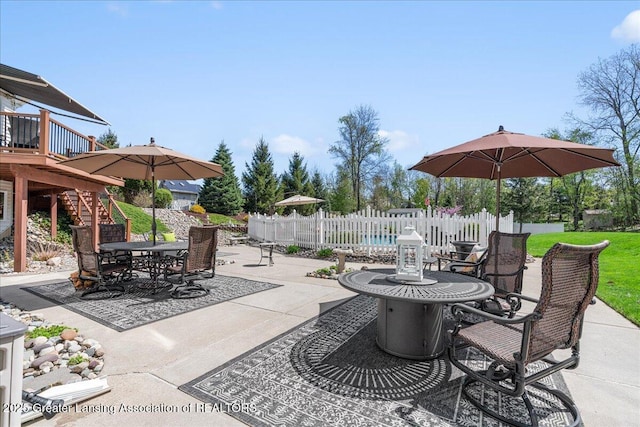 3012 Appaloosa Way, Lansing, MI 48906 - view of patio / terrace featuring fence, a deck, outdoor dining area, and stairway