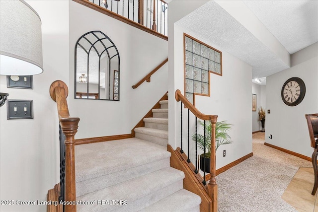 3012 Appaloosa Way, Lansing, MI 48906 - stairs featuring baseboards, a textured ceiling, and carpet floors