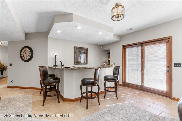 3012 Appaloosa Way, Lansing, MI 48906 - bar featuring baseboards and a textured ceiling