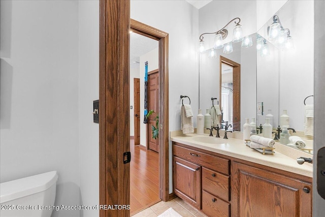 3012 Appaloosa Way, Lansing, MI 48906 - bathroom featuring vanity, tile patterned flooring, and toilet