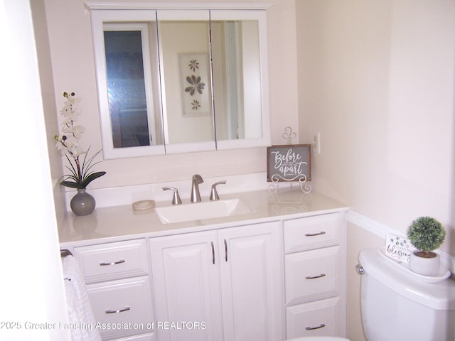 half bath featuring toilet and vanity