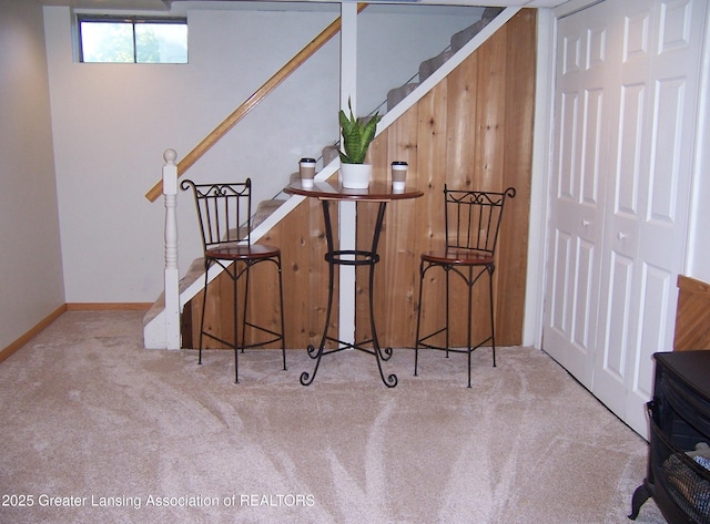 interior space featuring baseboards, carpet flooring, and stairs