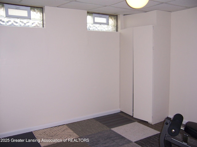 basement featuring a paneled ceiling
