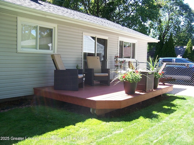 wooden terrace with a lawn