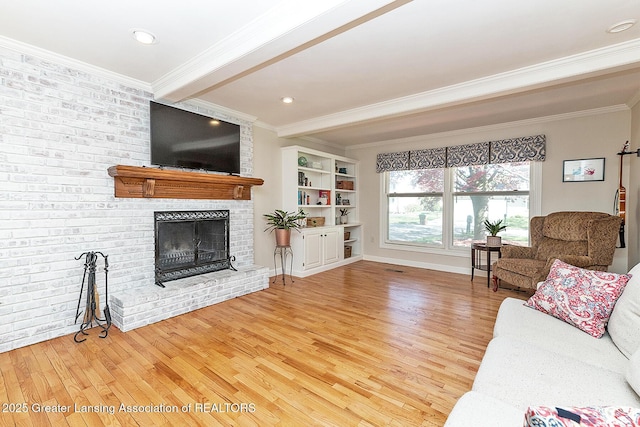 living room featuring ornamental molding, wood finished floors, a brick fireplace, baseboards, and recessed lighting