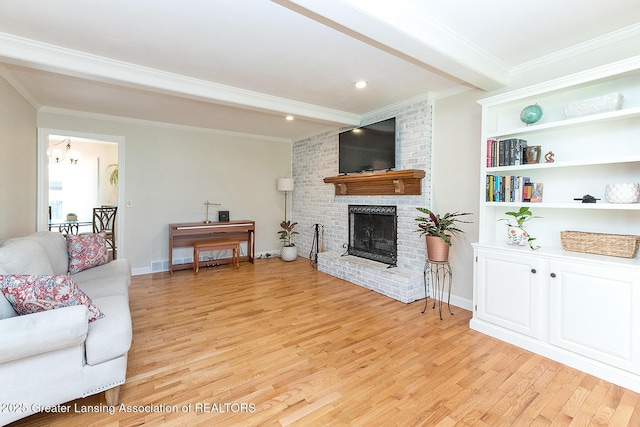 living room with light wood-style flooring, ornamental molding, a brick fireplace, beamed ceiling, and baseboards