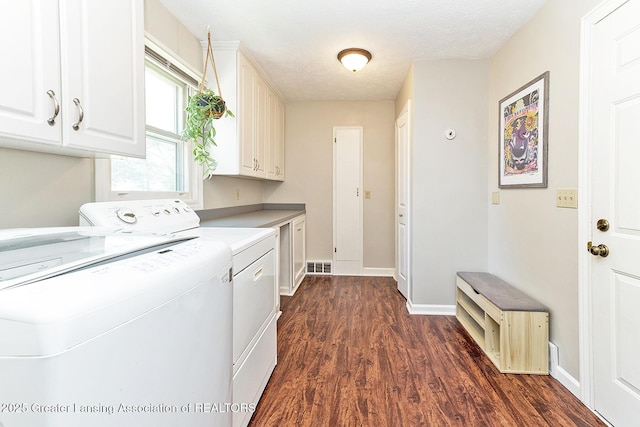 clothes washing area featuring cabinet space, washer and dryer, dark wood-style floors, and baseboards