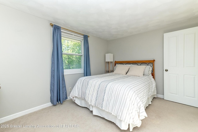 bedroom featuring carpet and baseboards
