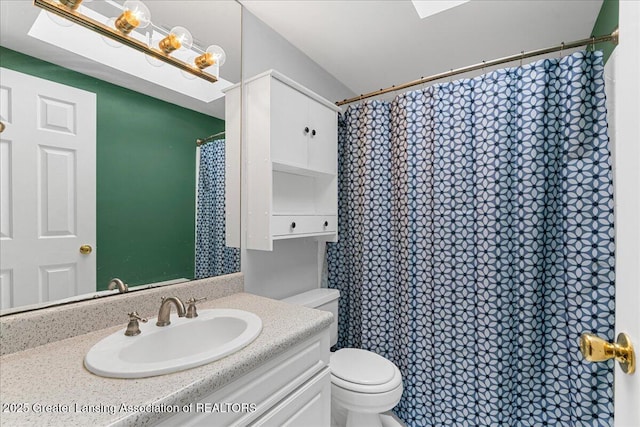 bathroom with vanity, toilet, and a shower with curtain