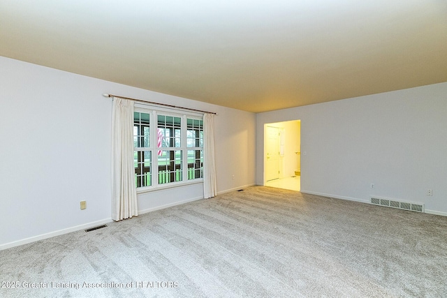 spare room featuring visible vents, baseboards, and carpet floors