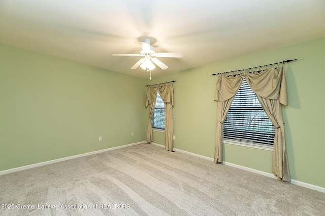 unfurnished room with ceiling fan, baseboards, and carpet