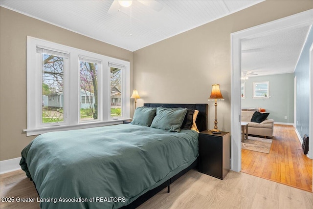 bedroom featuring baseboards and light wood finished floors