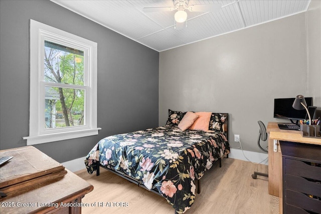 bedroom with light wood-style floors and a ceiling fan