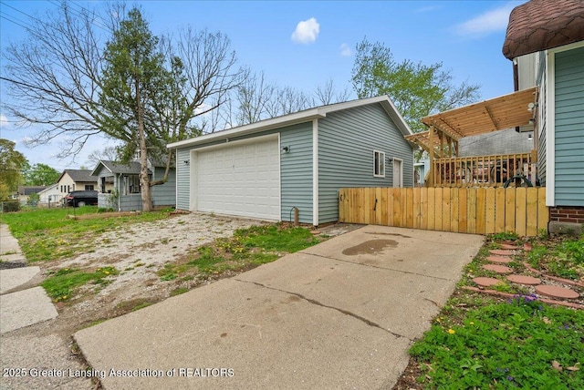 view of home's exterior featuring fence, an outbuilding, and a garage